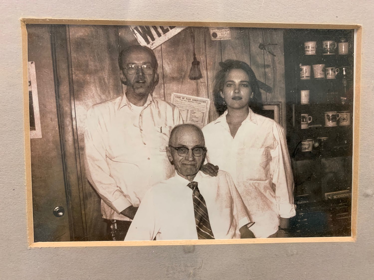 A photo of three generations of barbers in the Ohnstad family – Bob, his daughter Kristin and his late father.