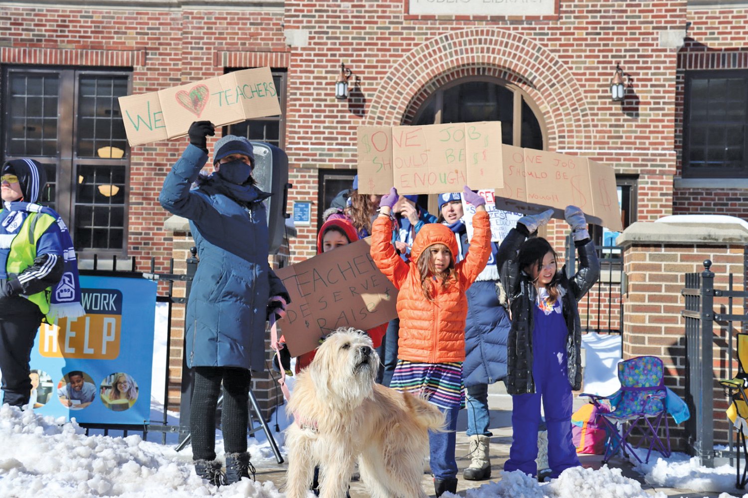 Wendy Ledesma was with children Santiago (age 11) and Noemi (age 9), and Pearl Jones (age 7), students at Green Central, and their dog, Jyn Erso, at Roosevelt on Tuesday, March 8 to stand with educators in Minneapolis. (Photo by Tesha M. Christensen)