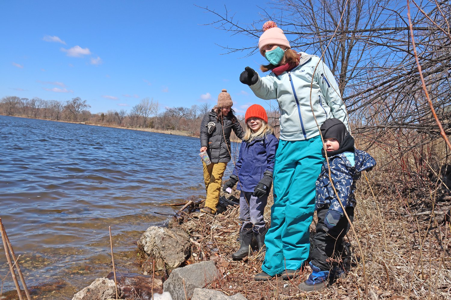 Nicole Cavender, who is Dakota, with Weston, 6, and Becket, 2.5 years, along with Ali Mailander and Hap (not shown) clean up trash along Lake Hiawatha on April 16, 2022. (Photo by Tesha M. Christensen)