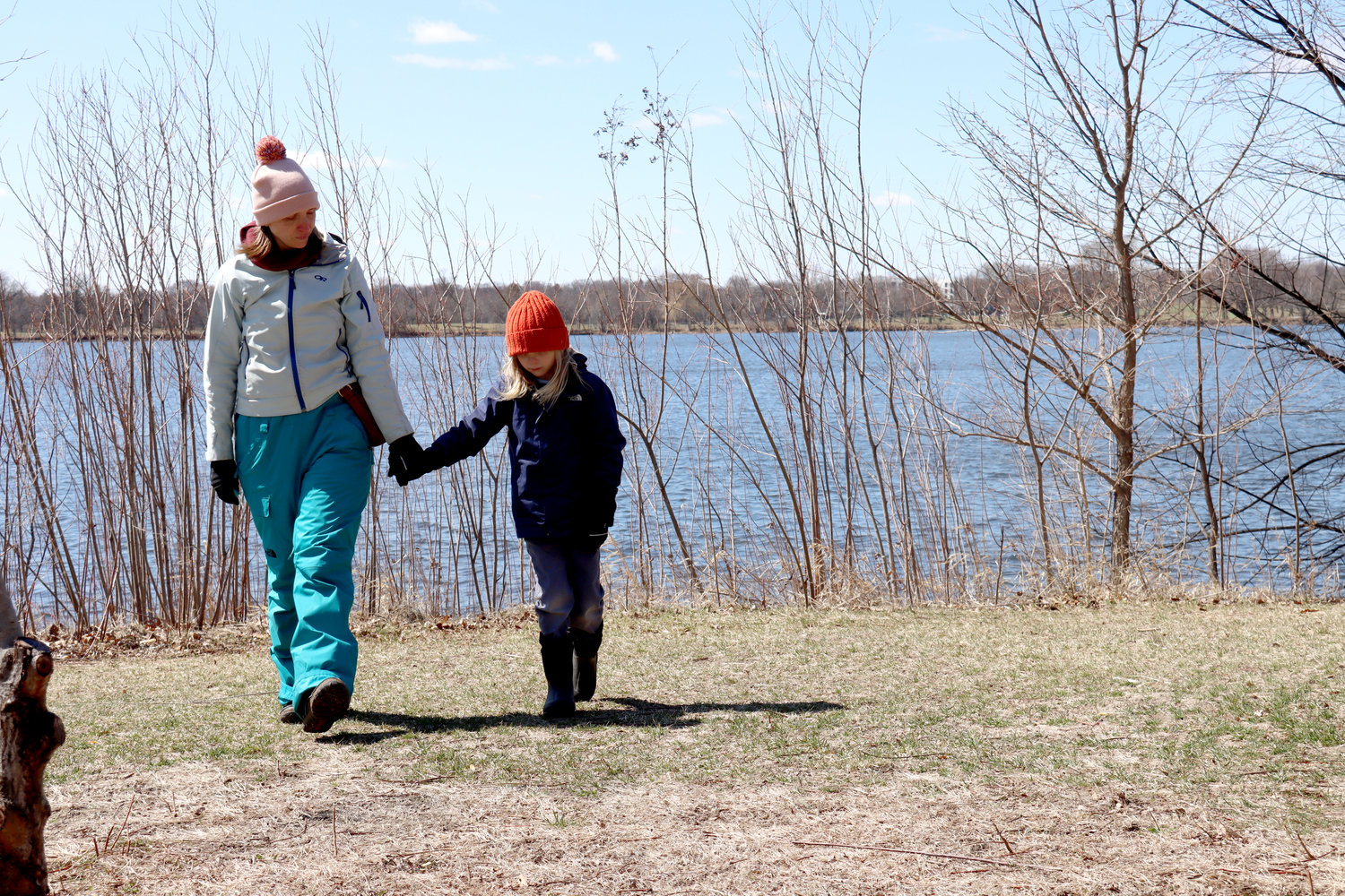 Nicole Cavendar comforts her six-year-old son, Weston, who is concerned about the ducks eating the trash in Lake Hiawatha.