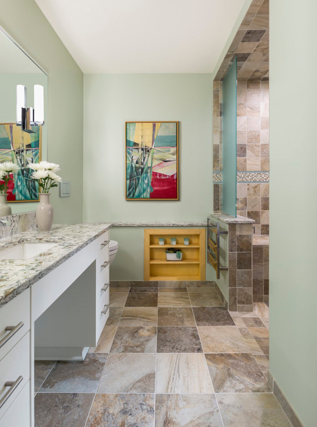 This bathroom by Sylvestre Remodeling & Design features a shower without a curb as it aids in mobility. Dangerous throw rugs have been removed. (Photos by Andrea Rugg Photography)