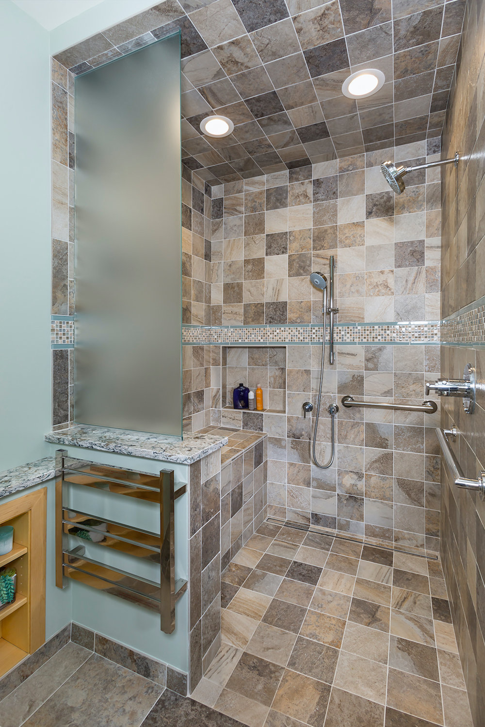 This bathroom by Sylvestre Remodeling & Design features a shower without a curb as it aids in mobility. Dangerous throw rugs have been removed. (Photos by Andrea Rugg Photography)