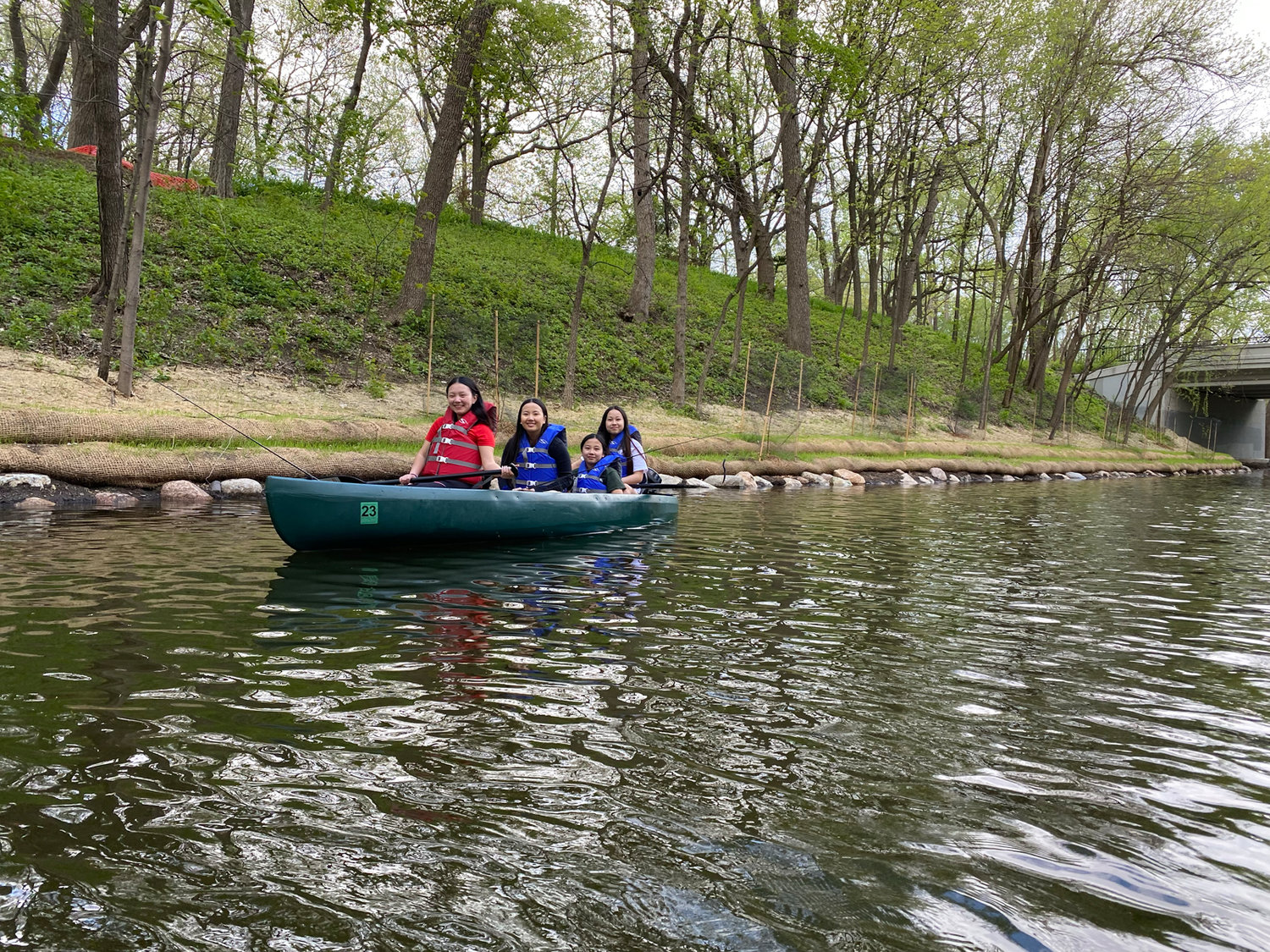 Xe Moua (left), with sisters Youa, Linda and Anna Yang of North Minneapolis, fish for bass in the Kenilworth Channel between Lake of the Isles and Cedar Lake on May 15. (Photo by Tesha M. Christensen)