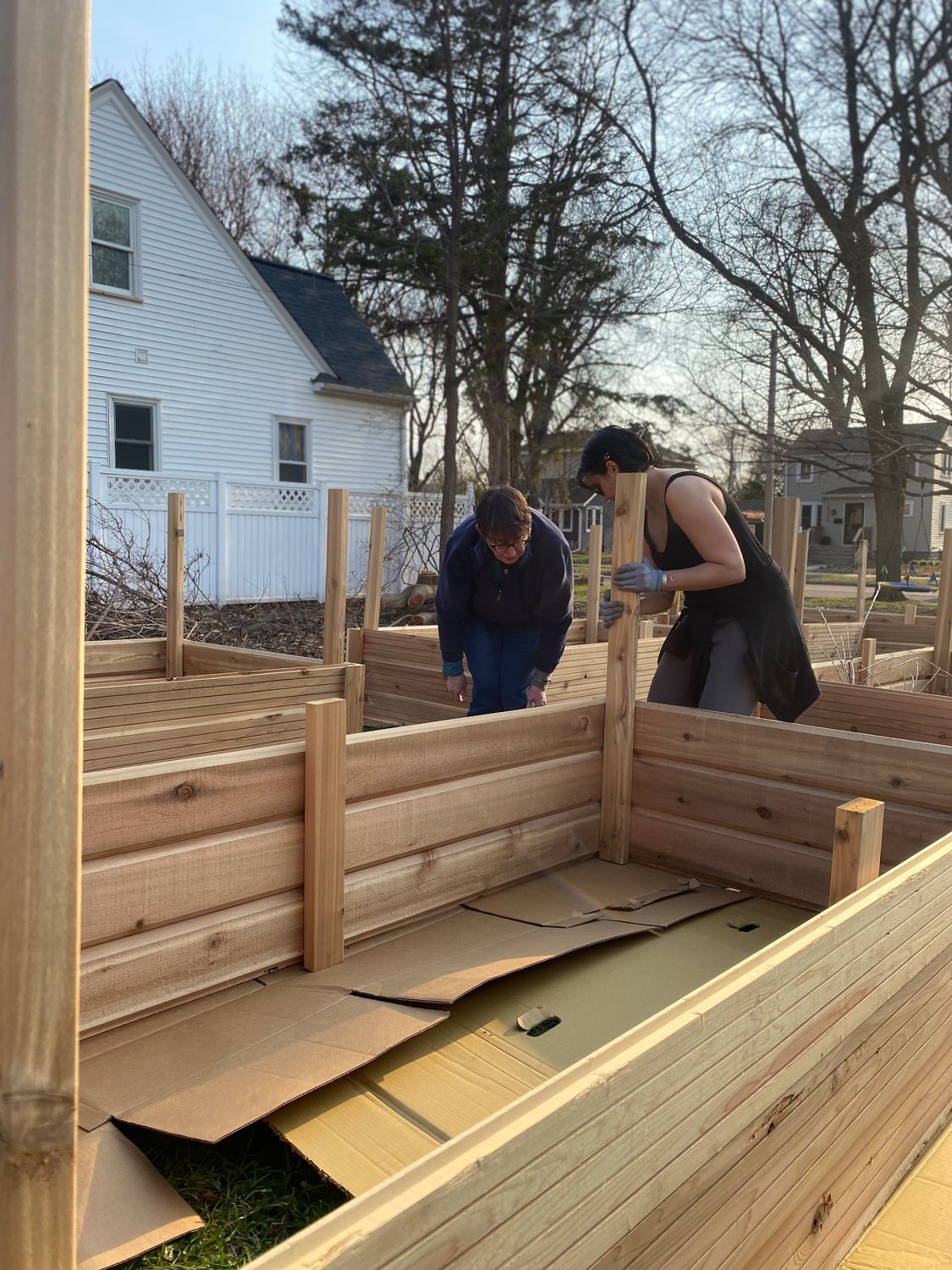 Volunteers build raised garden beds at the Giving Garden at Trinity Lutheran Church. Food grown will be donated to a food shelf.