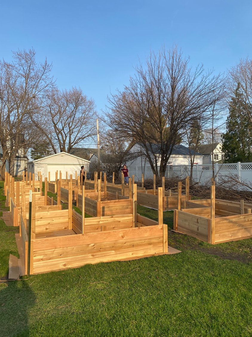Volunteers build and tend raised garden beds at the Giving Garden at Trinity Lutheran Church. Food grown will be donated to a food shelf.