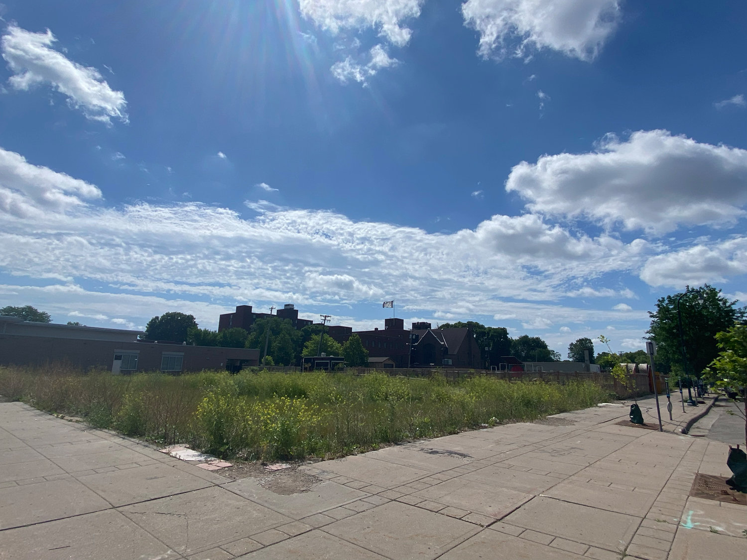 A view from E. Lake and 27th of the block where the Odd Fellows, Gandhi Mahal, MIGIZI and post office used to stand. The lots are mostly weeds now, with a fenced garden at the Gandhi Mahal property. June 2022