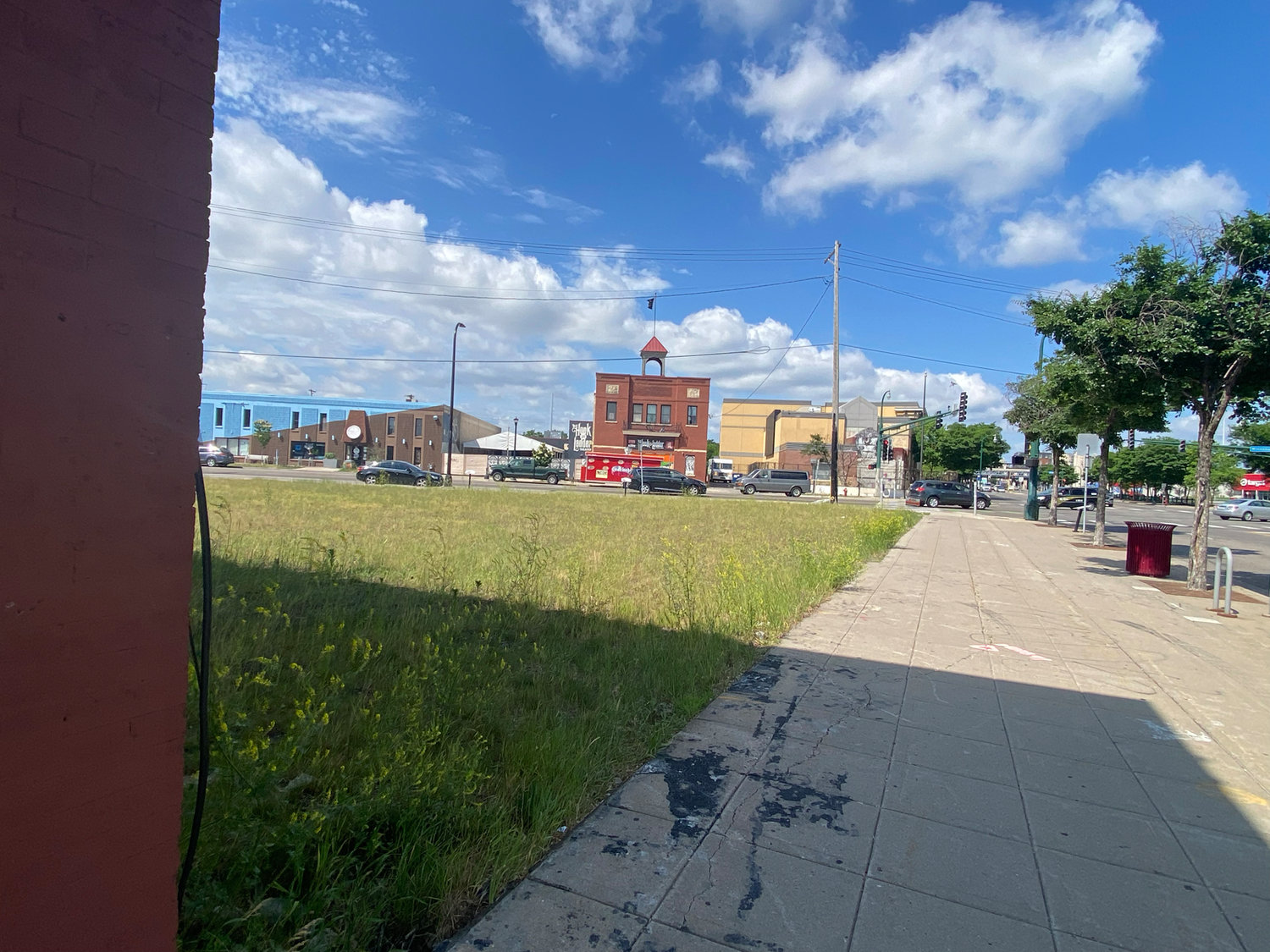 Looking at the lot that housed the Minnehaha Lake Wine & Spirits building towards the Third Precinct, which remains boarded and still smells of burnt when residents walk by two years later.