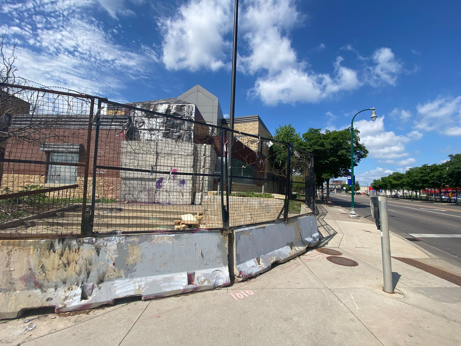 The 3rd Precinct remains boarded and blocked with barb wire two years later. It still smells of burnt items as passersby walk down the sidewalk. The sidewalk is still only partially open.
