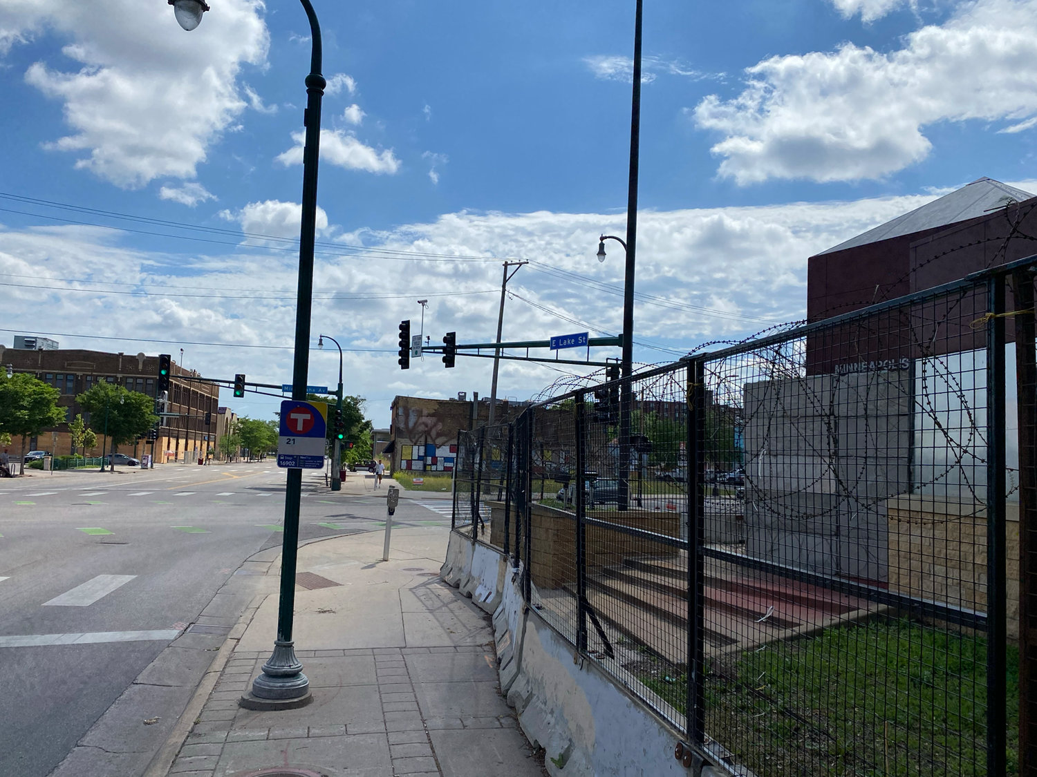 The view from the boarded and fenced 3rd Precinct looking east on Lake Street where  much of the destruction of buildings was centered.  Most of the area south of E. Lake remains vacant. (Photo by Tesha M. Christensen)