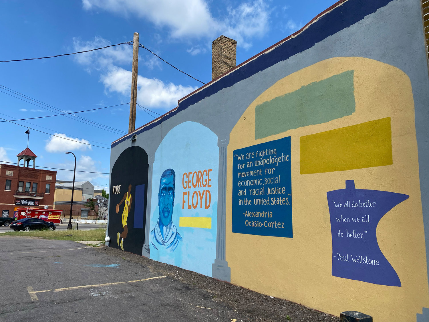 Murals on the side of LV's Barbershop in liquor store parking lot. Across the street you can see the Hook & Ladder Theater, which suffered light damage and continues to hold live shows. (Photo by Tesha M. Christensen)