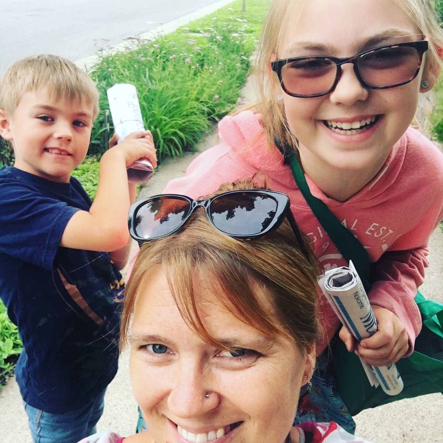 Tesha M. Christensen and her kids deliver papers in the Longfellow neighborhood in 2019.