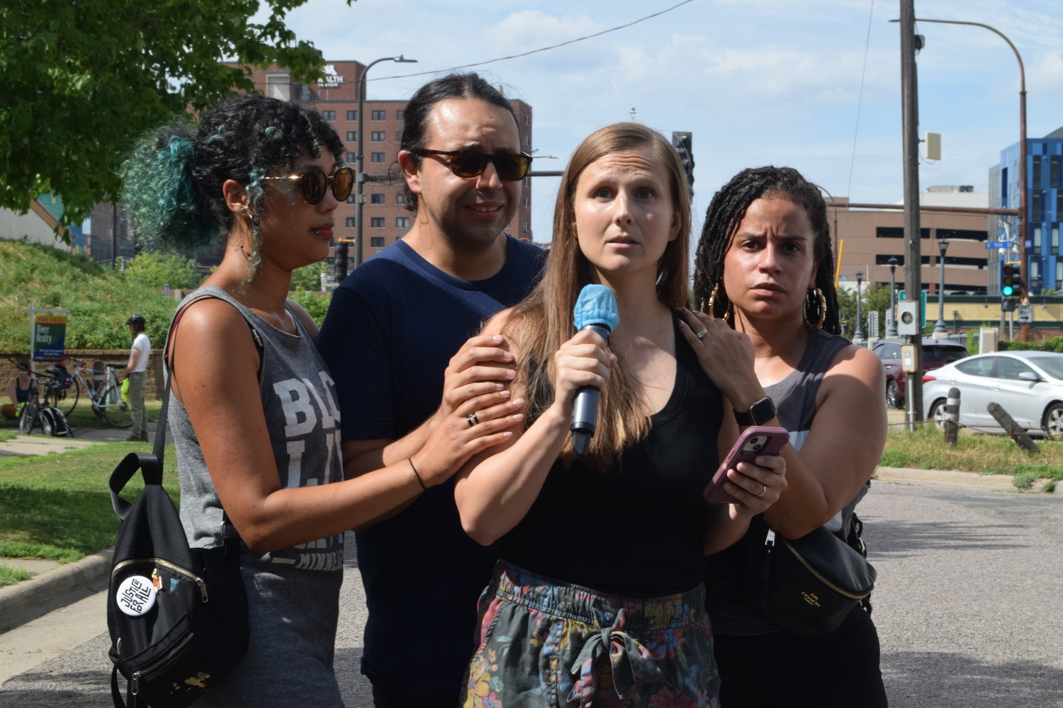 Tekle’s sister Kelsey Romero speaks during an event to honor him on Saturday, July 16, 2022, two days after he was shot by snipers. A social worker, Romero said, "Don't tell us you had no other choice. Don't tell us you need more training. We've seen you take people into custody safely." (Photo by Jill Boogren)