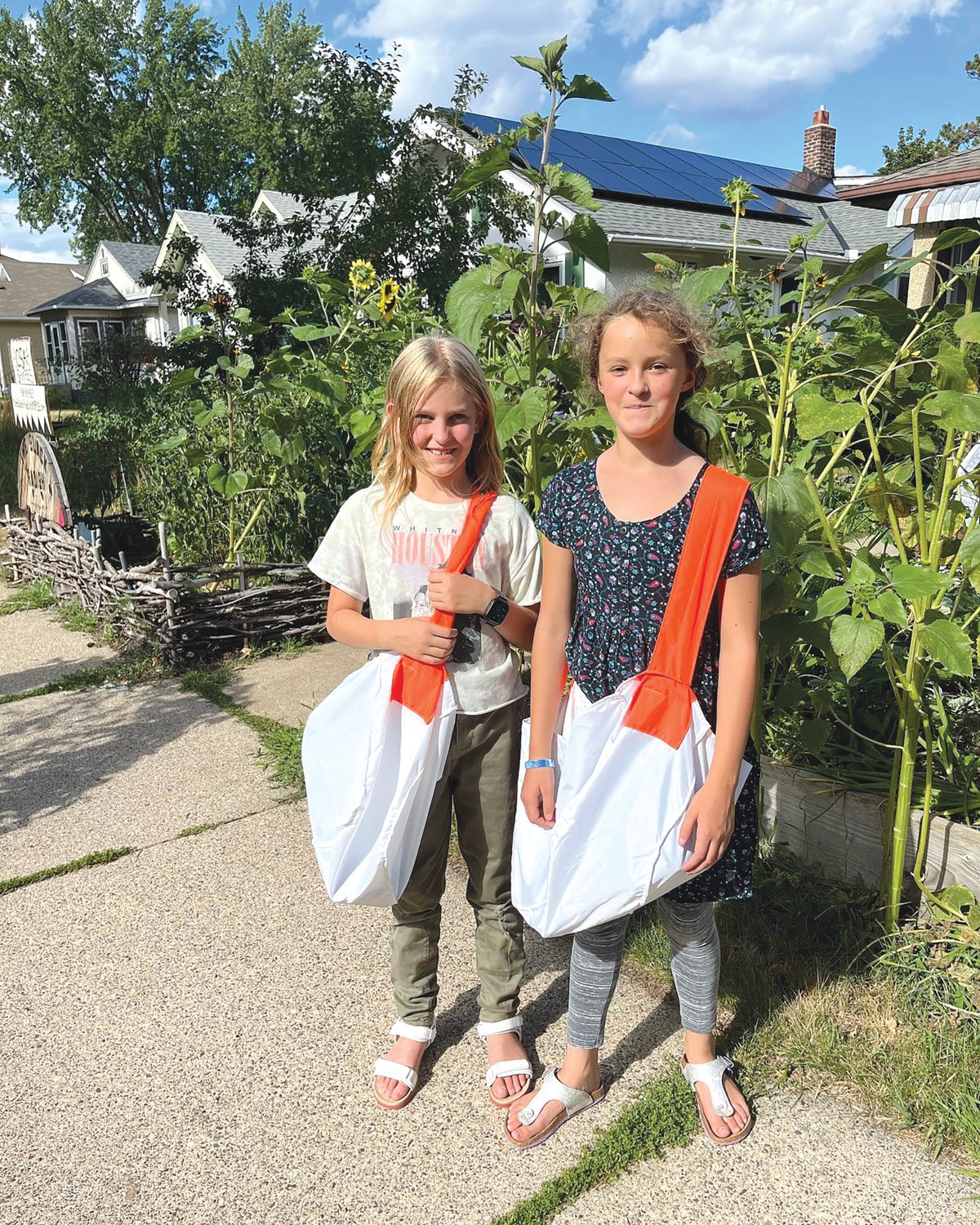 Audrey Young (left) and Annika Lindorfer, both age 10, are two new carriers for the Longfellow Nokomis Messenger. They said it is calming to walk around and see different parts of the neighborhood. (Photo submitted)