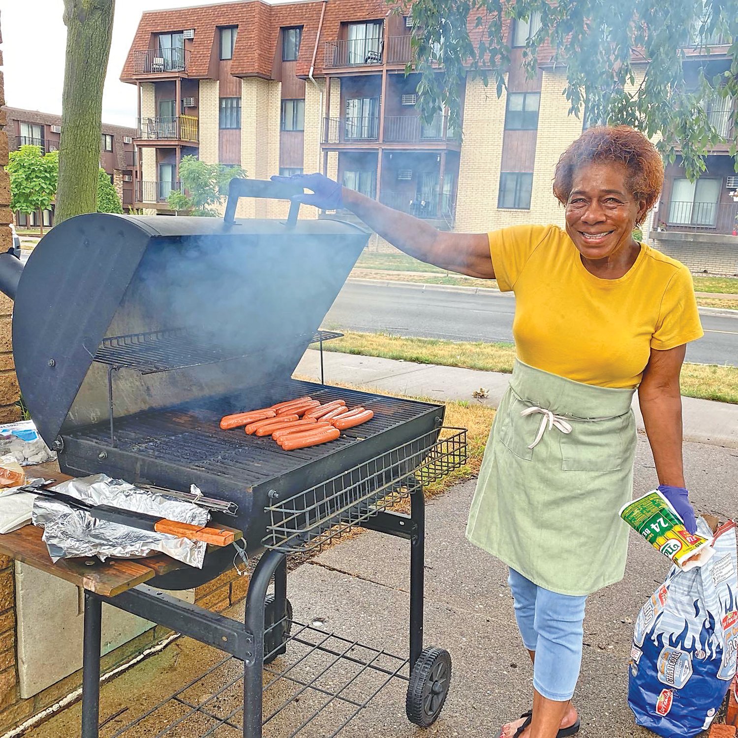 Pastor Prince Lee's sister, Betty Lee, managed the grill at the Riverside Church picnic during Nokomis Days.
