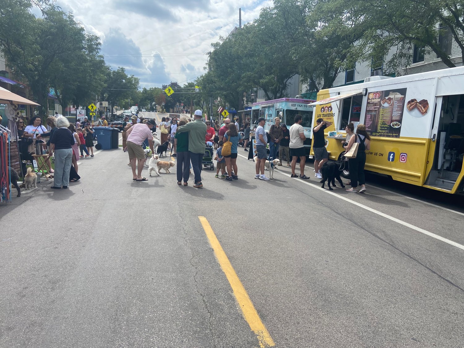 People and dogs gather at booths and food trucks at Woofstock on Saturday September 10, 2022 hosted at Sheridan Ave S & W 43rd St.