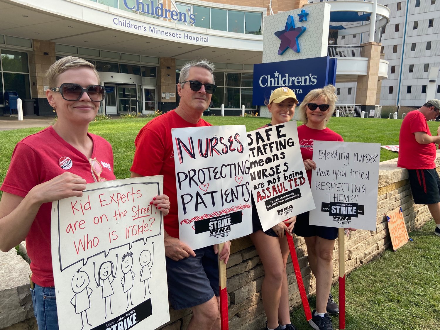 Tricia Ryshkus (far left) and Susan Gerome (far right) are nurses at Children's Hospital Minnesota, Minneapolis, 2525 Chicago Ave, striking for safe staffing and retaining nurses. Gerome has been working Children's Minneapolis for 37 years.