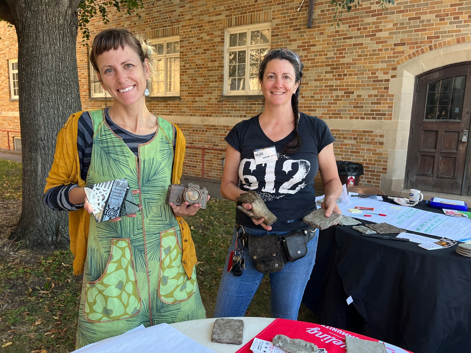 To show examples, volunteer coordinator and instructor Jess Berman Tank (above left) and CAFAC artistic director and founder Heather Doyle shared art forms cast from objects selected by George Floyd Square community members as meaningful to them. Shown here, from left to right, is an enamel design, metal casts of photographer Billy Brigg’s camera and caretaker Jeanelle Austin’s hand, and a texture pressed in clay.