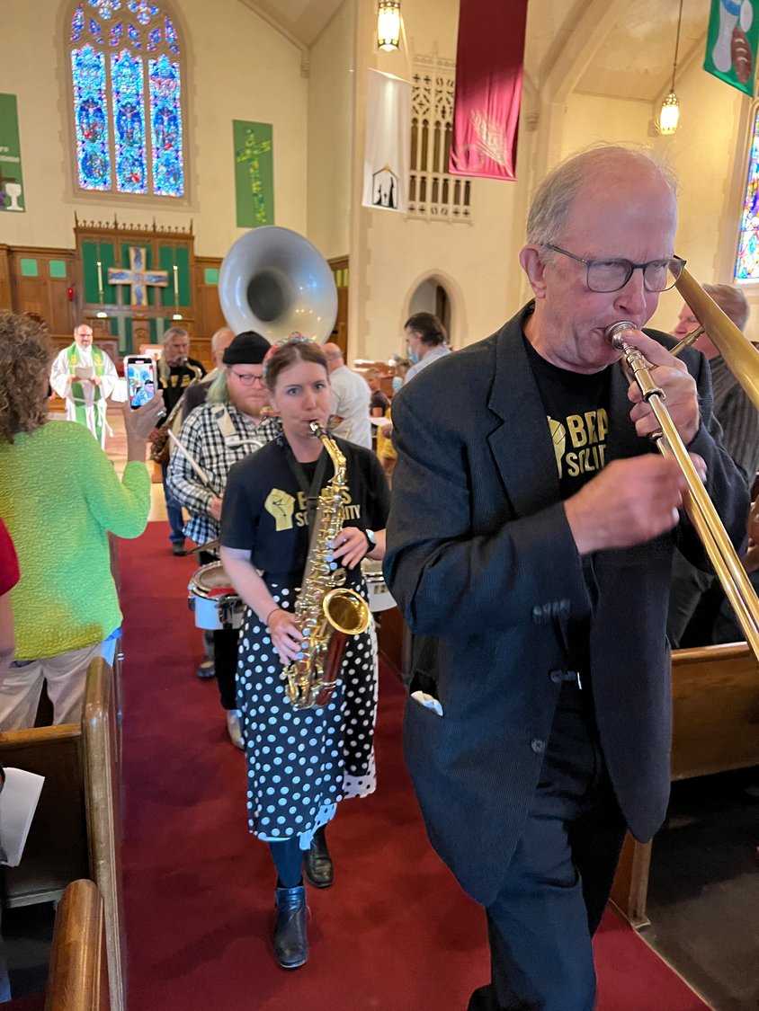 Members of Brass Solidarity lead a musical procession out of the Calvary sanctuary on Sept. 11.