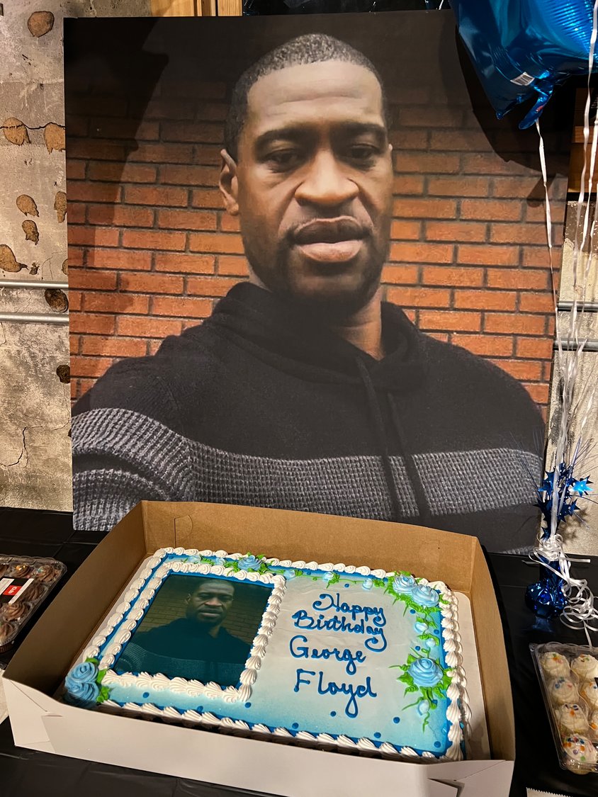 The frosting on a cake with his picture reads, “Happy Birthday George Floyd.”