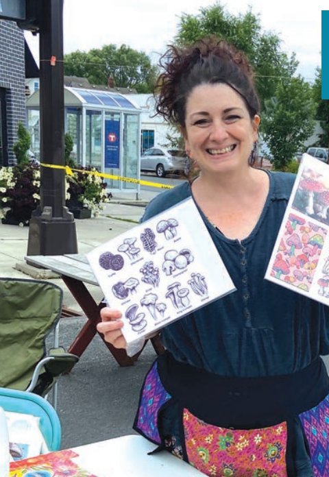 Tammy Ortegon, owner of ColorWheel Gallery at 46th and Grand, shows pictures of mushrooms and other fungi during a community pop-up event along Nicollet Ave. to inspire art-makers in the community