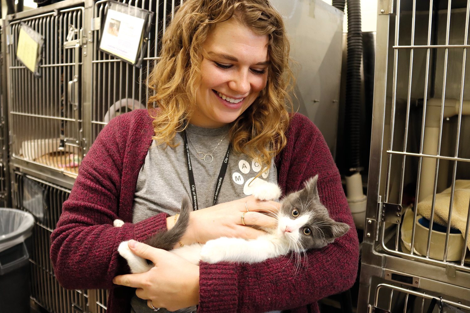 Madison Weissenborn holds three-month-old Llasa prior to a free adoption day event on Dec. 9, 2022 meant to clear out the shelter before Christmas. Weissenborn is the volunteer and community partnership coordinator at Minneapolis Animal Care and Control.  (Photo by Tesha M. Christensen)