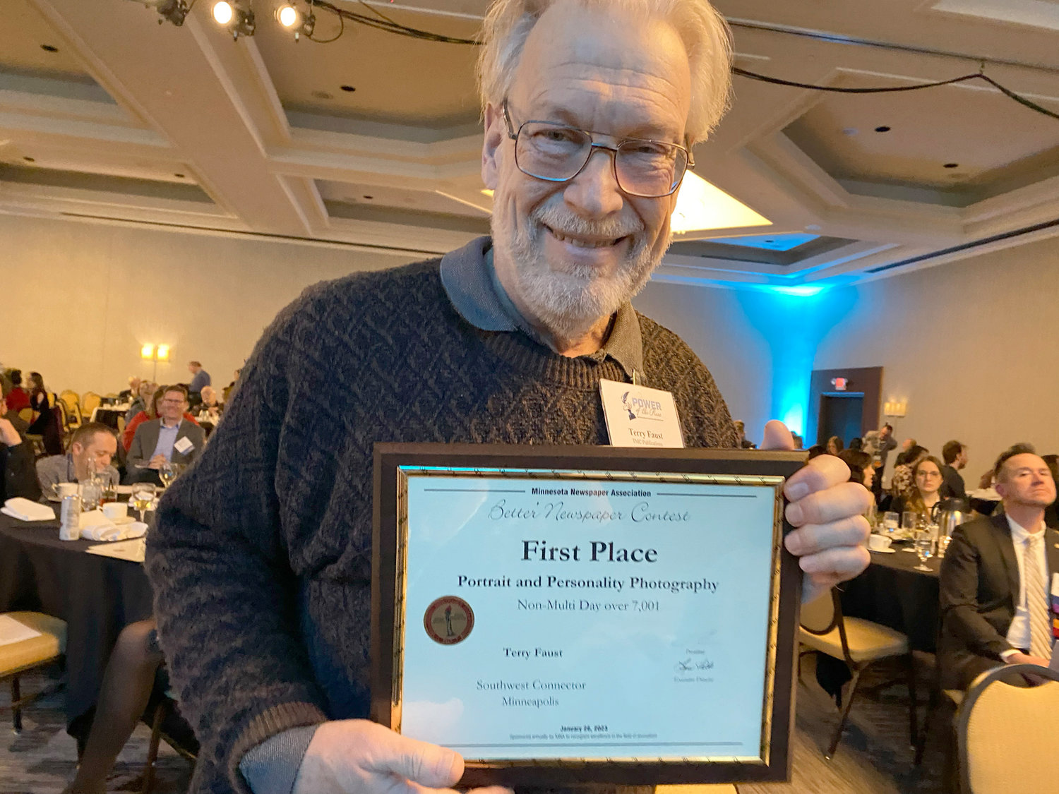 TMC Publications CO photographer Terry Faust accepts a first place award during the Minnesota Newspaper Association Better Newspaper Contest on Thursday, Jan. 26, 2023. First Place, Photography Portrait and Personality - Terry Faust, “Affordable housing architect,” Southwest Connector, March 3, 2022. Judge’s comment: Good composition, fill flash, and posing of the subject, each of which is a skill of its own.
