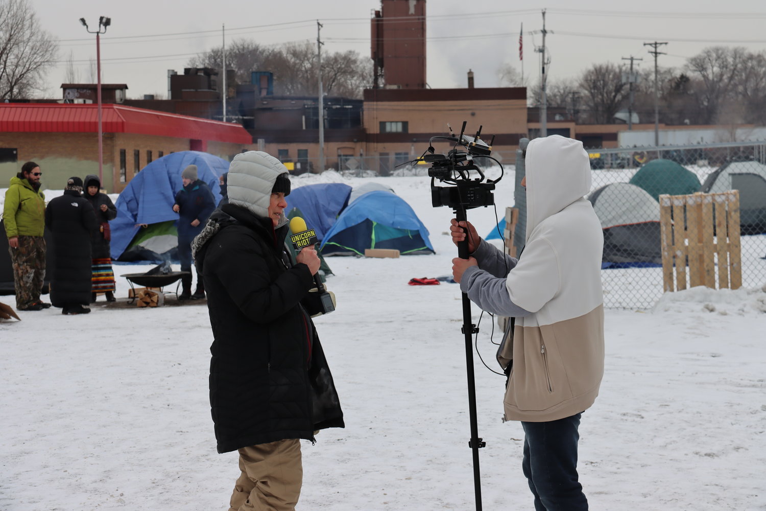 Delaney Russell, a south Minneapolis resident, is interviewed by Unicorn Riot during the occupation by Indigenous people and allies of the Roof Depot that began at dawn on Tuesday, Feb. 21 and lasted through evening when Nenoocaasi Camp was disbanded forcibly on the orders of Mayor Frey by over 100 officers and 50 squad cars. (Photo by Tesha M. Christensen)