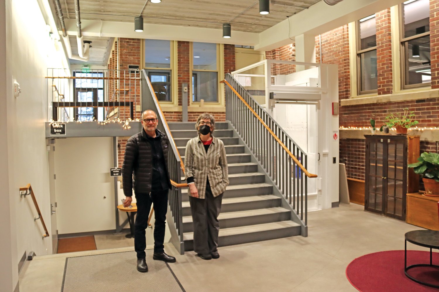 Marcelo Pinto (left) of Alliiance and Jackie Hayes of the Center for Performing Arts stand in the space that bridges old and new. An elevator was added to aid accessibility. (Photos by Tesha M. Christensen)