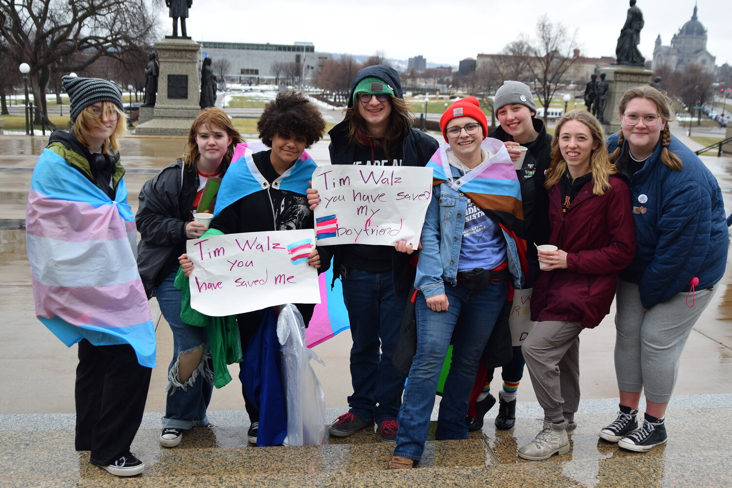 (Left to right) Meg Bexell, Eden Urban, Ace Austin, Jack Bexell, Savannah Berg, Elizabeth Dimock, Katie Dimock and Samantha Pollack attend the march for trans rights outside the Minnesota Capitol on March 31, 2023.