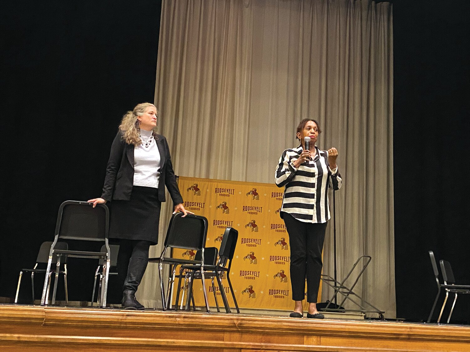 Karen DeYoung of DeYoung Consulting Service (right) and Minneapolis Interim Chief Operating Officer (COO) Heather Johnston talk to about 155 people about the 3rd Precinct on April 18 at Roosevelt High School.