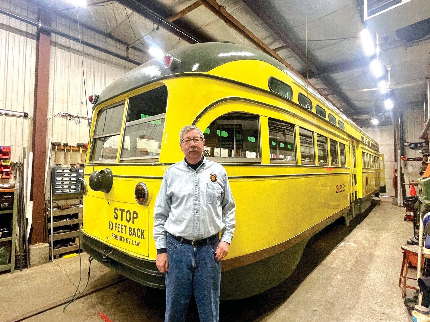 Aaron Issacs, chairman of the board of the Minnesota Streetcar Museum, stands in front of car No. 322, stored and repaired in the historic car barn. See inside this building during Doors Open Minneapolis on May 13-14. More at trolleyride.org.