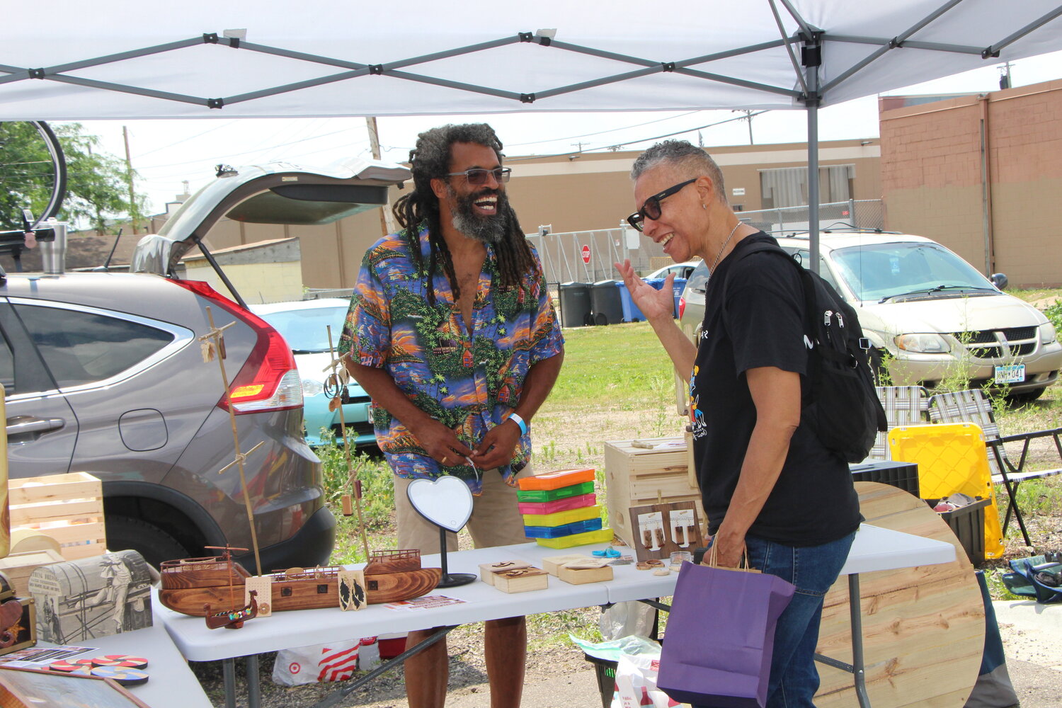 A vendor sells handcrafted wooden art and jewelry at the Soul of the Southside festival on Monday, June 19.