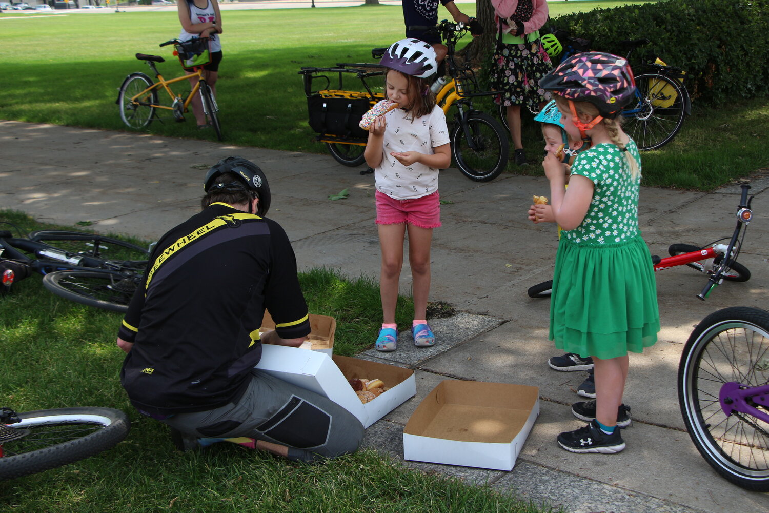 Mario Macaruso gives donuts to Joyful Riders Club outside of the Minnesota State Capitol on Saturday, June 17th for the DJ dance party ride.