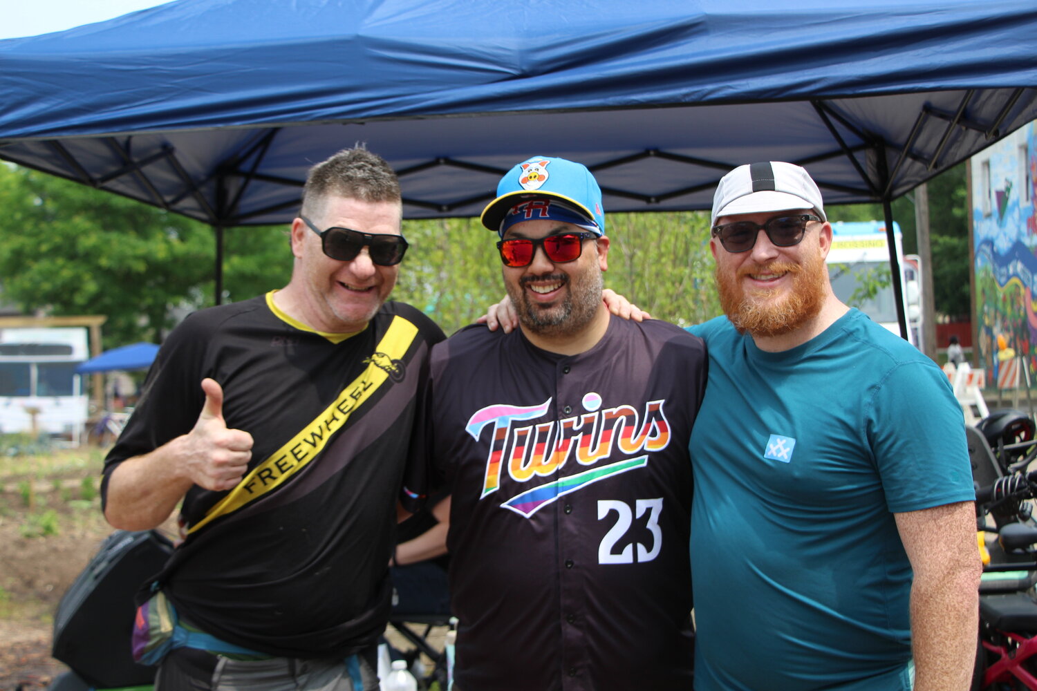 Partick Stephenson, Eric Moran and Mario Macaruso smile for a photo during the Joyful Riders Club DJ dance party at the Frogtown Fair on Saturday, June 17.