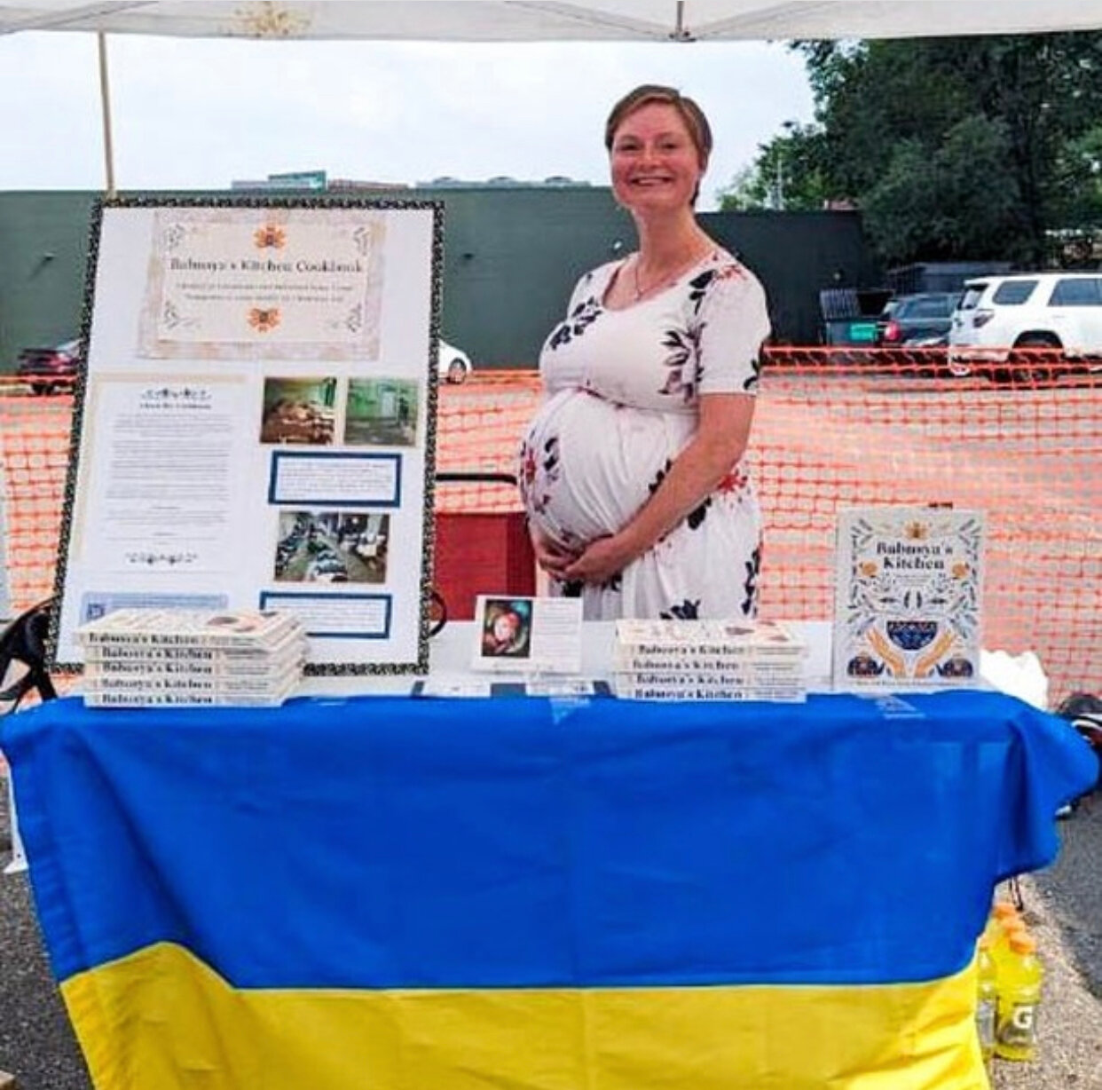 Sarah Friedman sells Babusya’s Kitchen cookbooks to raise funds for Ukraine relief efforts at the Oxendale's vendor fair.