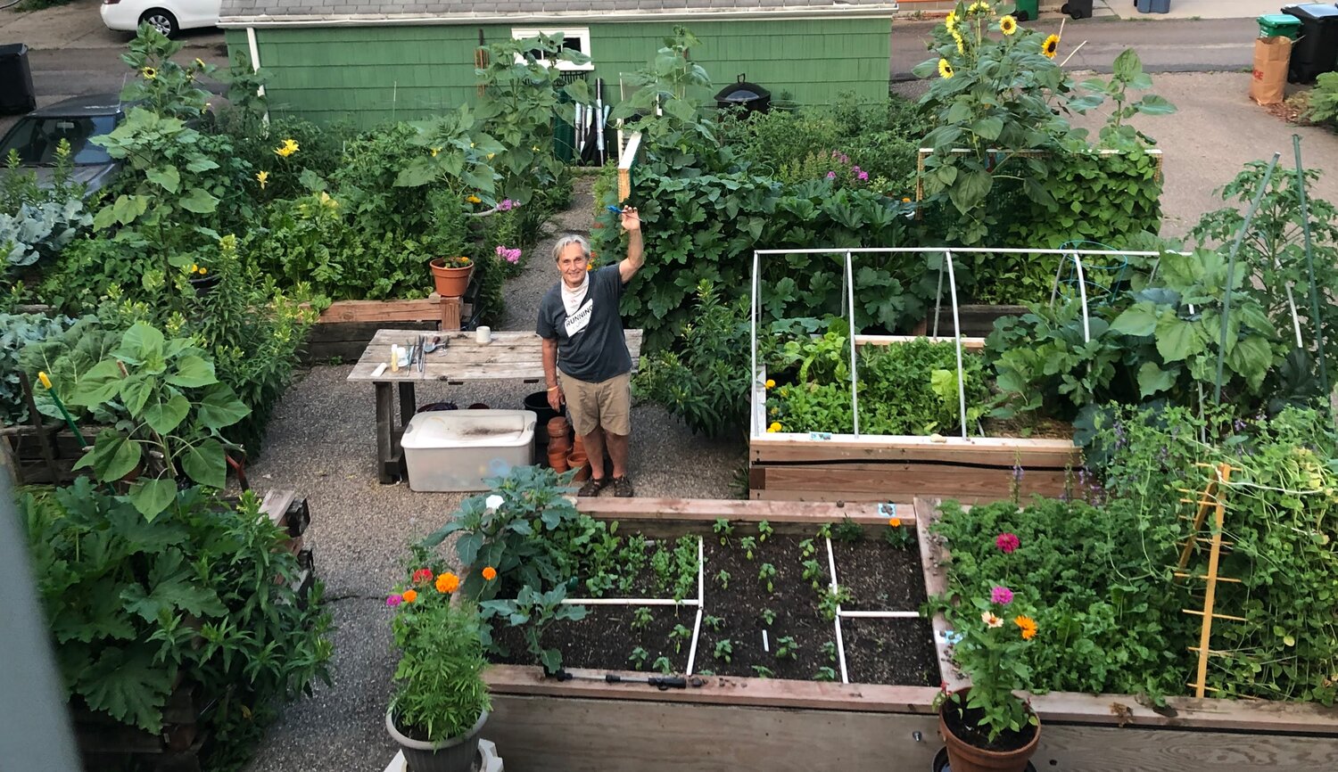 Craig Neal stands in the urban garden growing on his city plot that feeds nine neighboring families.