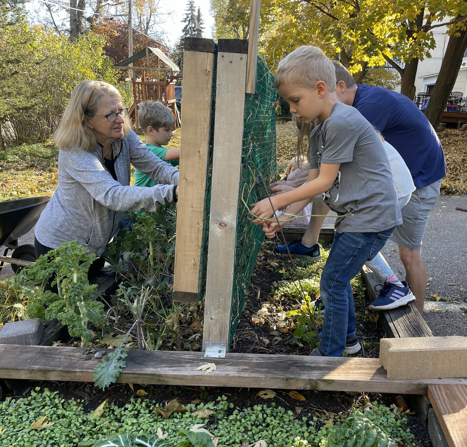 Patricia Neal works with children to tend their neighborhood sponsored garden.