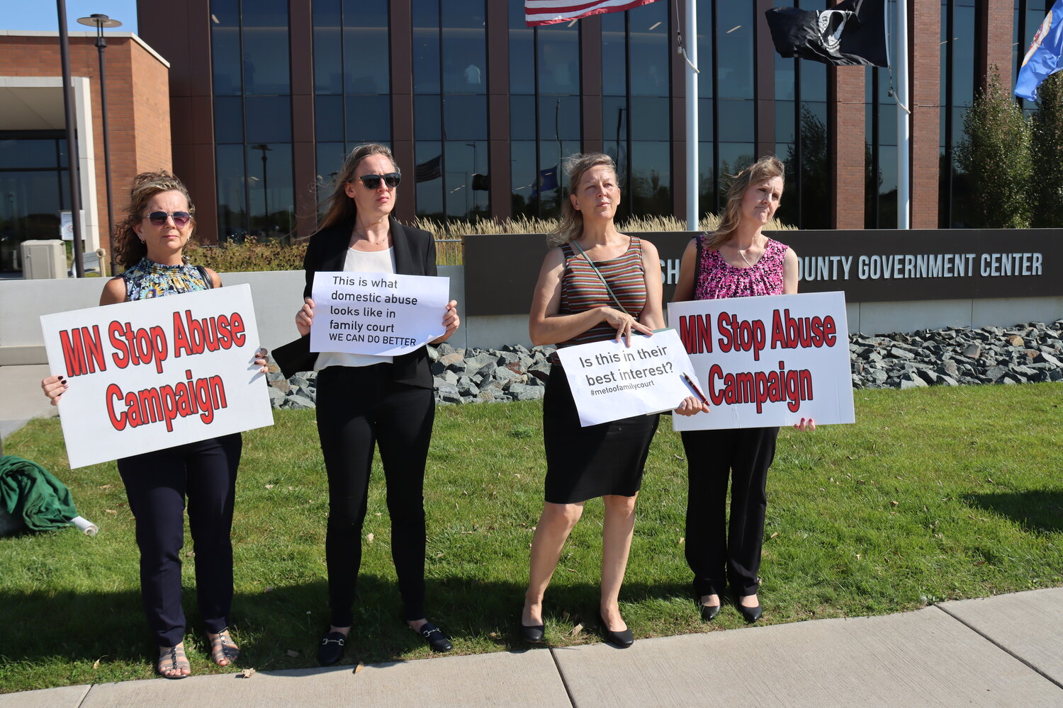 Advocates hold up signs while protesting before and after the hearing for Dani at the Sherburne County Courthouse on Oct. 2, 2023.