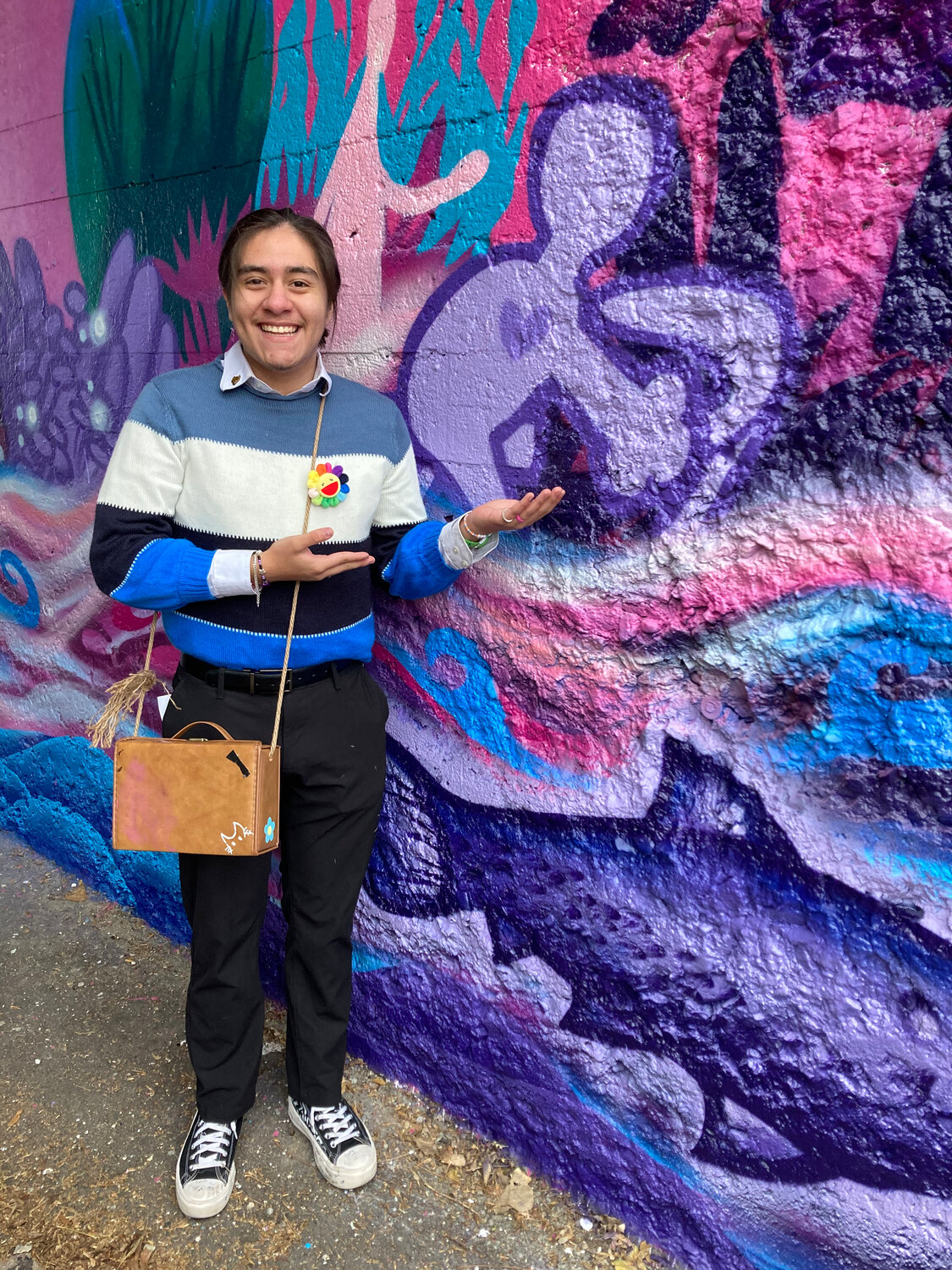 "If you look at it closely you can see a little blue guy holding a SIGN not a hammer. Nonetheless, I first sketched that little dude just a few years ago and to see it now on a mural it means so much more than just paint," said Hego Centeno, a sophmore at Hiawatha Collegiate High School (HCHS). "You might also be wondering what the little dude means or is called. I called him “The kid” and to me he represents the youth in someone. The strength, bravery, hunger, pride and more in someone. It might mean something else to you who knows. I don't think this mural needs anything else other than the people's ideas and thoughts to be heard and thought of. May this mural bring peace and harmony between two communities and really show the meaning behind what we call home."