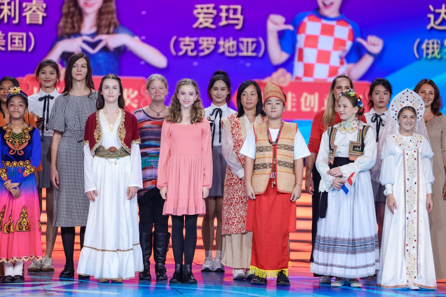 During the Chinese Bridge closing ceremony, Sage Houdek (at front in center wearing pink) and Kristi Papenfuss ( in back wearing sripes) join other guardians and contestants who were given awards. Sage earned first place among U.S. contestants, as well as an Outstanding Performance Award. (Photo submitted)