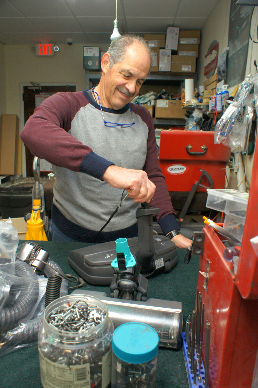 Russ checked the circuitry in a motorized nozzle/brush assembly at one of A-1's repair tables.