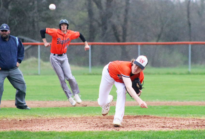 Ben Miller started off pitching in the first inning while a Poynette runner gears up to run towards third base.