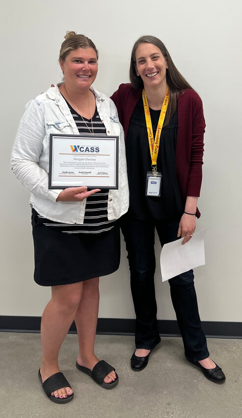 Morgan Cherney, left, and Jane Mathes, right, pose with the WCASS award.