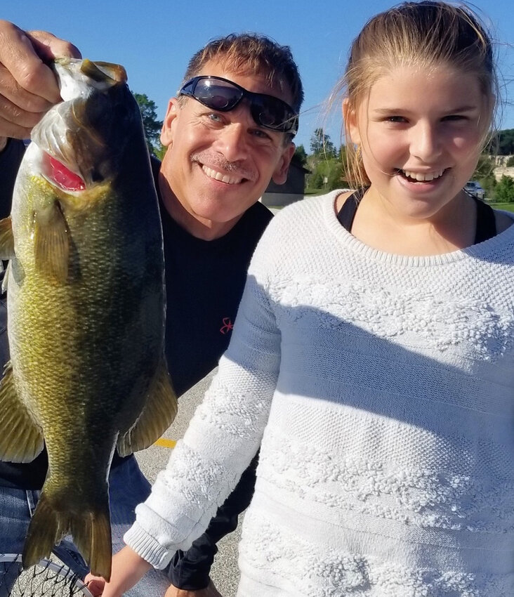 A Father's Day shore fishing outing a number of years back produced this lasting memory of a smallmouth bass caught, photographed and released.—Photo By Kevin Naze