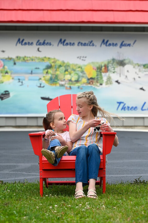 Children enjoy a treat outside a Three Lakes frozen yogurt shop.