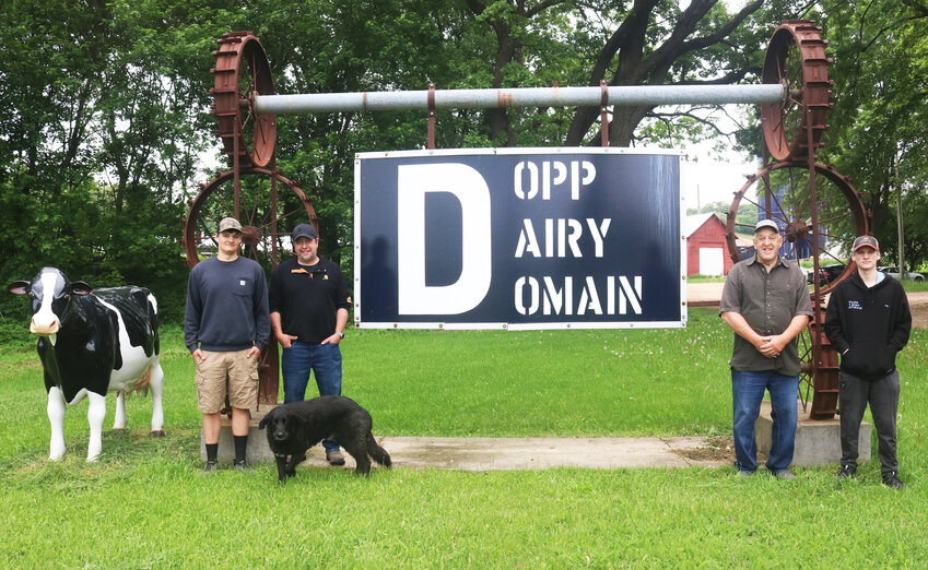 Dopp Dairy Domain has been in the family for seven generations. Pictured here are three generations of the Dopps: Mason, Dan and his furry friend Luke, Phillip, and Liam. Not pictured are Dan’s son Thomas and daughter Alyssa, who were helping with hoof trimming day, and his wife Kristen.