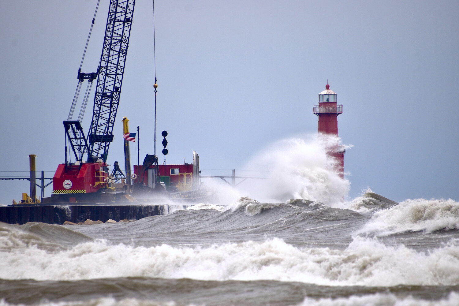 Waves pushed by gale-force southeast winds Tuesday, Nov. 19, battered the new sheet piling and Roen Salvage's moored barge and heavy equipment at Algoma's south breakwall. Strong northwest winds were in the forecast for the tail end of the week, but were expected to settle nicely for the gun deer hunting opener.