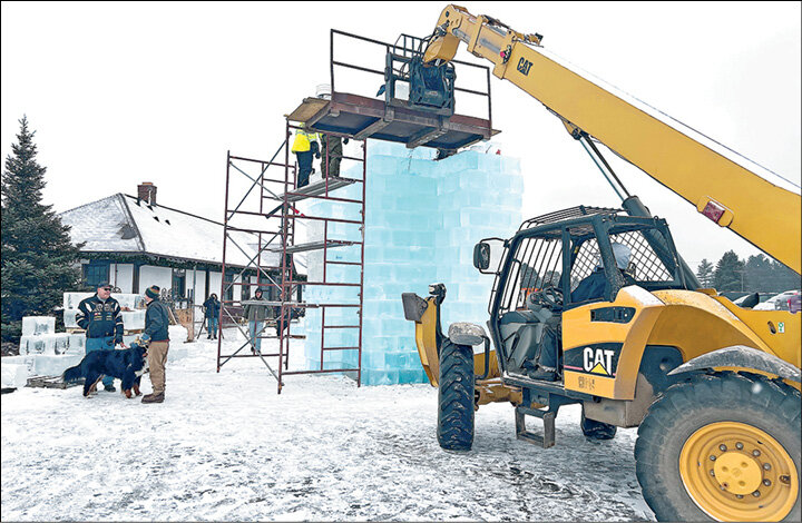 The Eagle River Fire Department used heavy equipment and scaffolding to constuct the ice castle towers Friday afternoon.