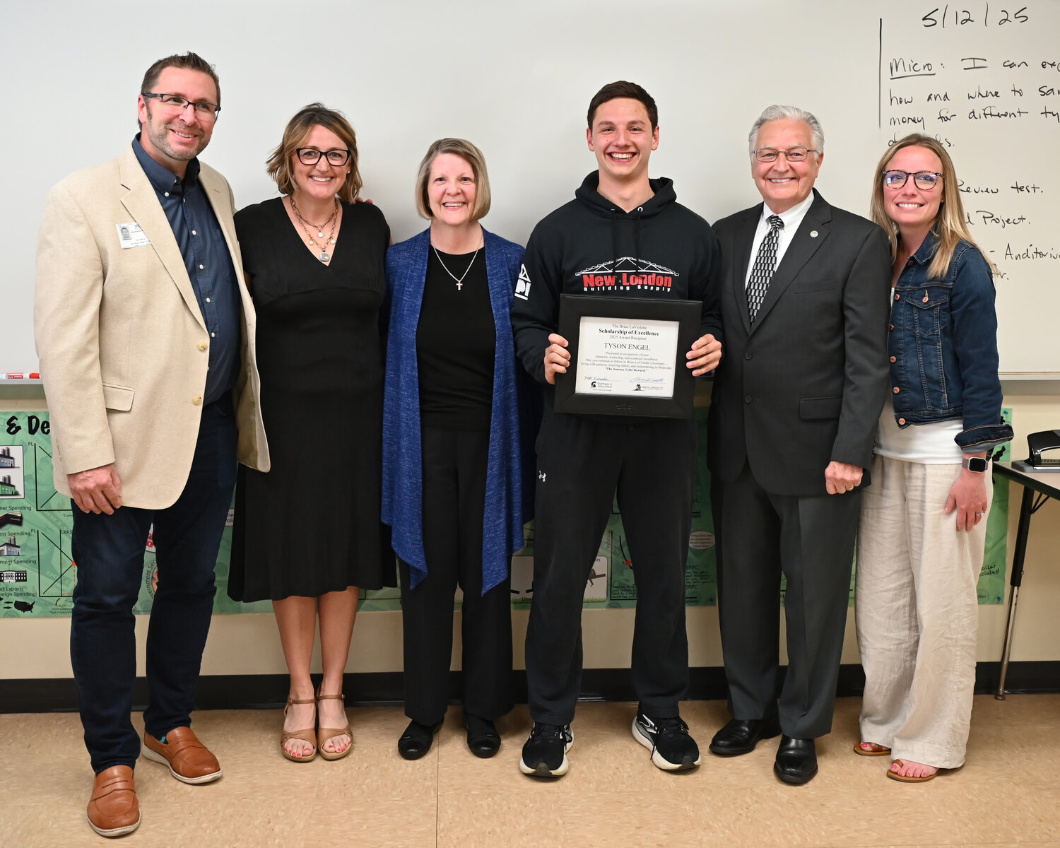 The LaViolette Family, along with representatives from De Pere High School and the Greater Green Bay Chamber, surprised Engel in person at school to present the scholarship. Pictured, from left, are Matt Rentmeester, Greater Green Bay Chamber; Brian LaViolette Scholarship Foundation Associate Director Kristin Kreuser; Brian LaViolette Scholarship Foundation Vice President Renee LaViolette; Tyson Engel; Brian LaViolette Scholarship Foundation President Doug LaViolette; and Stefanie Delahaut, Greater Green Bay Chamber.
