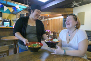 first-time customer, Mrs. Reyn Martin shares a laugh with Mai Vang. &quot;The food is great,&quot; she said.